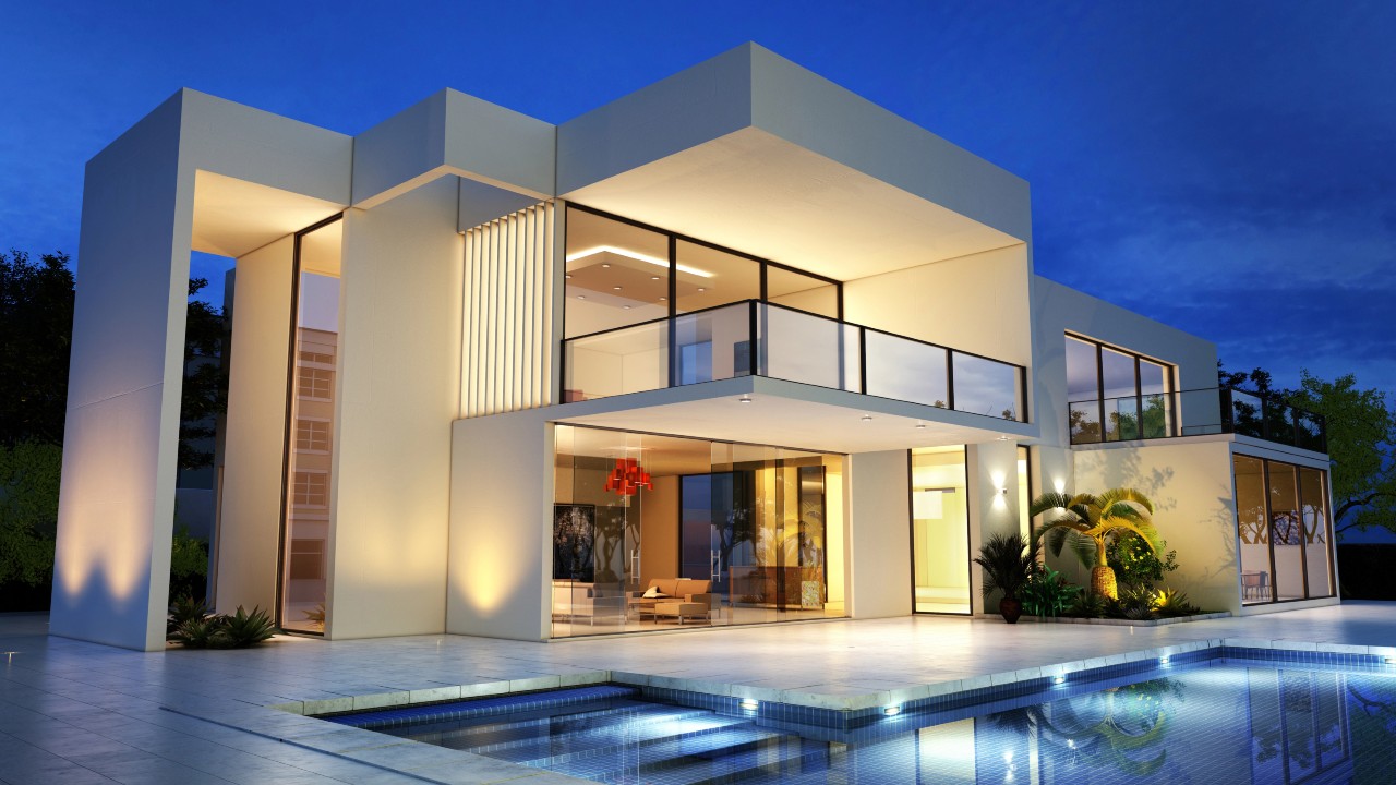 Una moderna casa a due piani al tramonto mette in mostra un esempio di case di lusso con grandi finestre in vetro e luci interne brillanti. L'esterno presenta una piscina, un design elegante e un paesaggio minimalista, il tutto sullo sfondo di un cielo blu intenso.