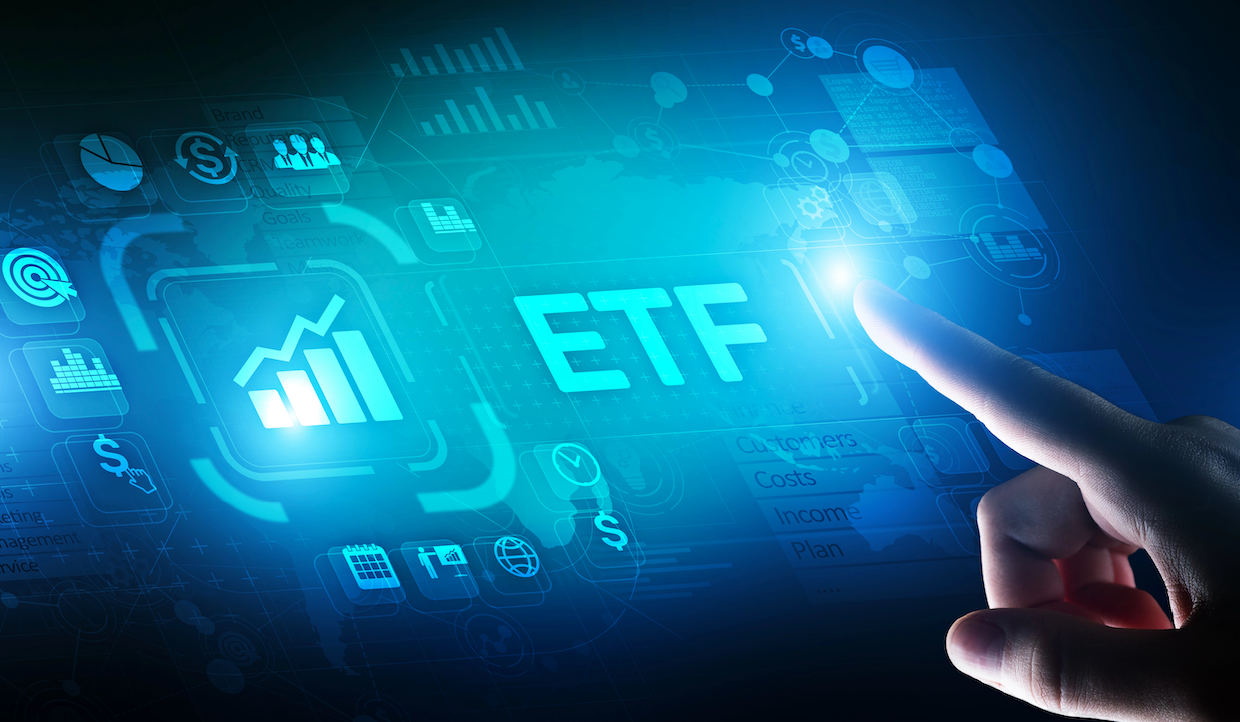 A hand touches a glowing digital screen displaying the acronym "ETF" with financial icons, including a stock chart, around it. The scene is futuristic with blue light effects and transparent data graphics.