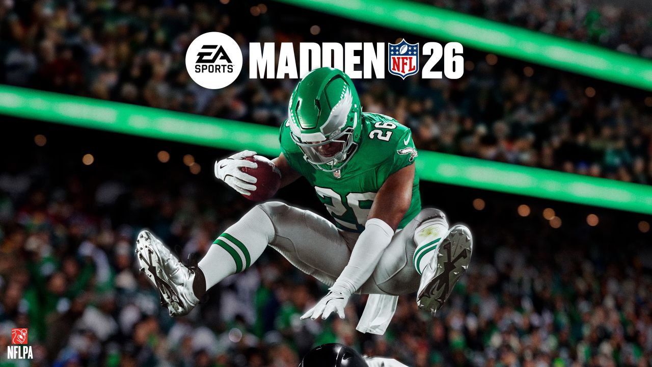 Un giocatore di football con una divisa verde e bianca salta su un avversario durante una partita, con il logo "EA Sports Madden NFL 26" visualizzato in alto su una folla dello stadio sfocata.