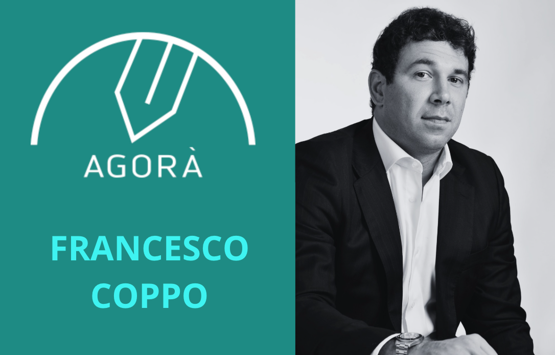 Immagine divisa: a sinistra il logo Agorà e il nome "Francesco Coppo" in grassetto; a destra un uomo in giacca e cravatta seduto e con lo sguardo rivolto in avanti su uno sfondo chiaro.