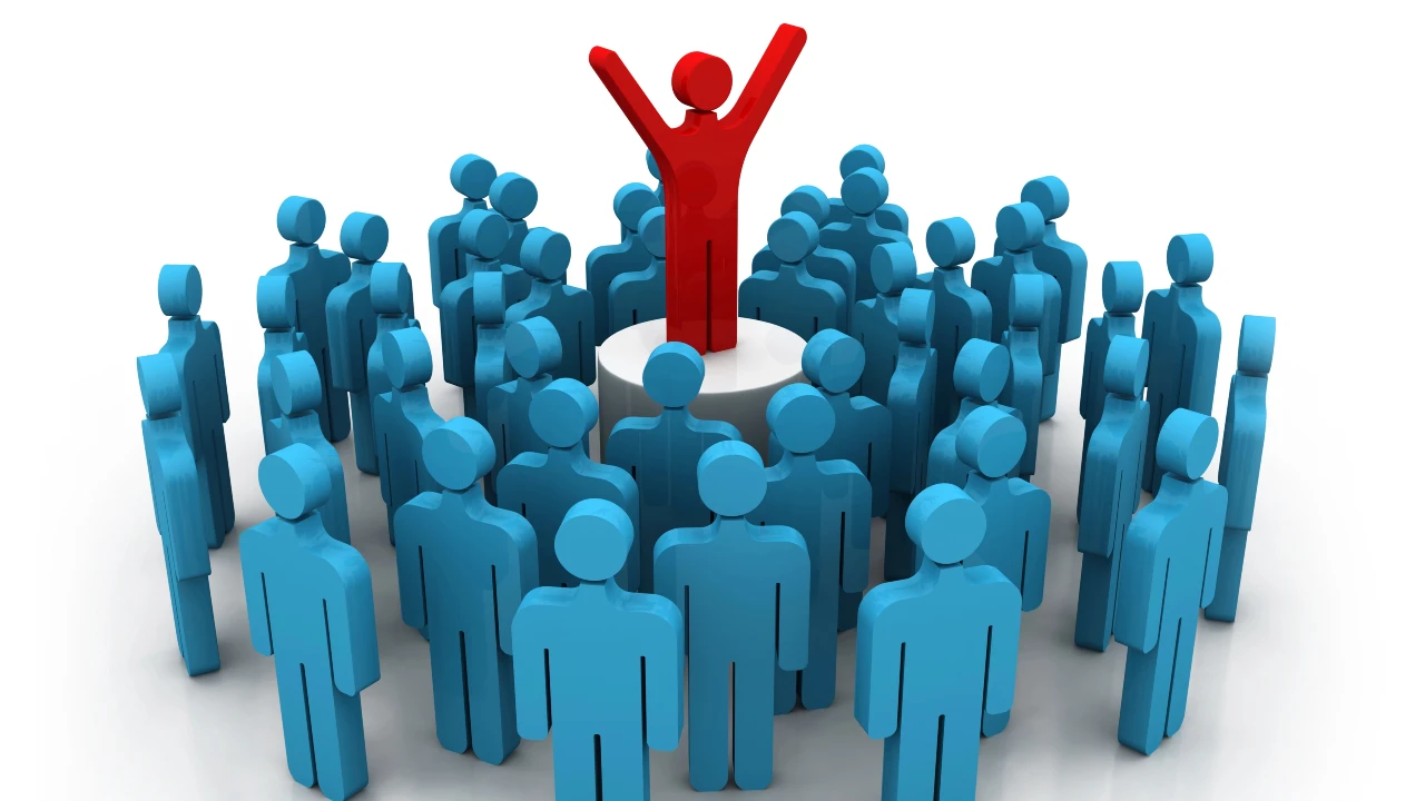 Una folla di figure umane blu circonda un'unica figura rossa in piedi con le braccia alzate, che simboleggia la leadership o il distinguersi dal gruppo. Il riferimento va alla comunicazione nelle imprese familiari.