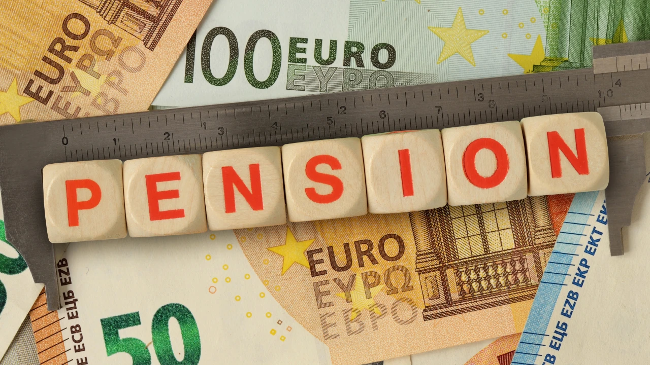 Wooden letter blocks spelling "PENSION" are placed on top of a ruler, with various euro banknotes in the background—reflecting financial planning for those exploring where-to-retire-southern-europe.