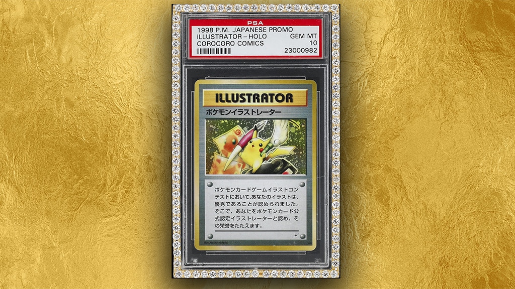 Una carta Pokémon Illustrator giapponese del 1998, classificata PSA 10 GEM MINT, esposta in una custodia tempestata di diamanti su sfondo oro. La carta raffigura Pikachu con in mano un pennello e strumenti da disegno.