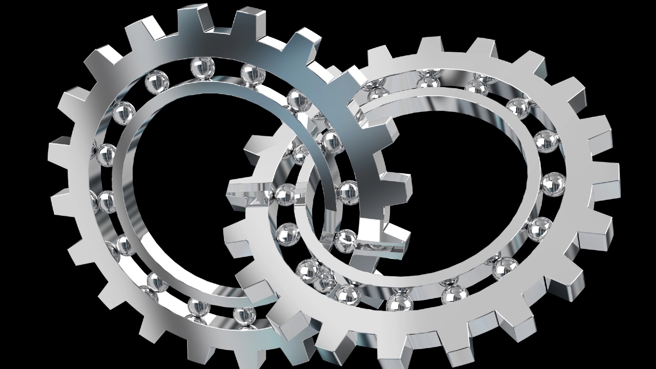 Ingranaggi metallici intrecciati su fondo nero, immagine simbolica del mercato italiano di private equity e venture capital tra più deal e raccolta debole