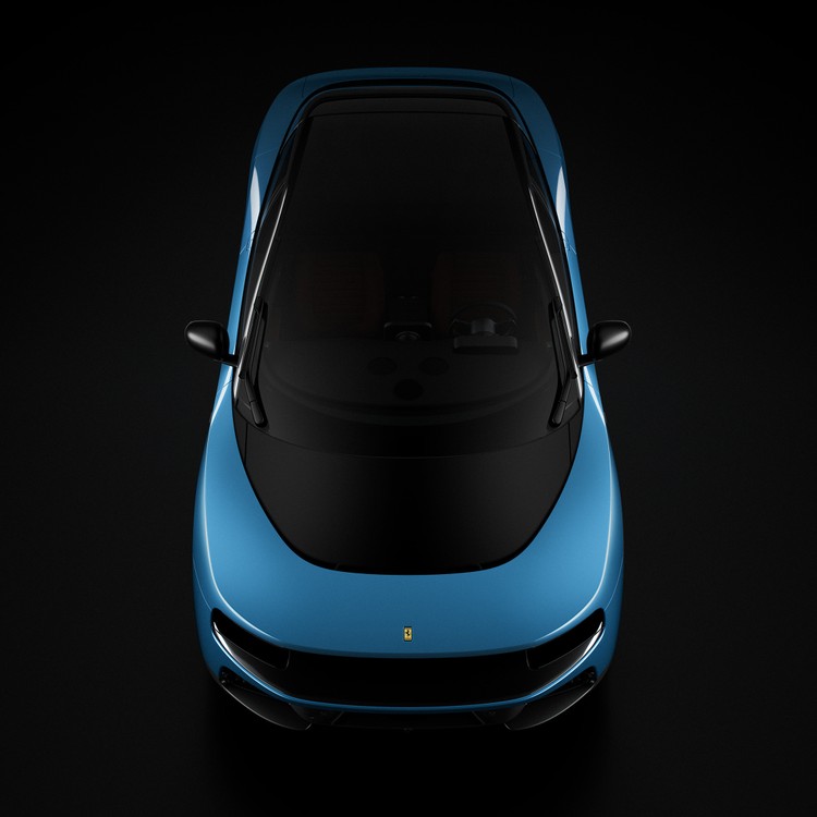 Vista dall'alto di un'auto blu Ferrari su sfondo nero, con tetto e parabrezza scuri.