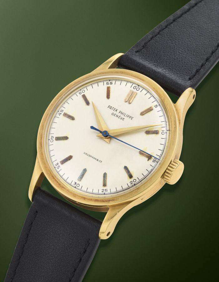 Orologio Patek Philippe Geneve con cassa dorata, quadrante bianco, lancette dorate e blu, e cinturino in pelle nera.
