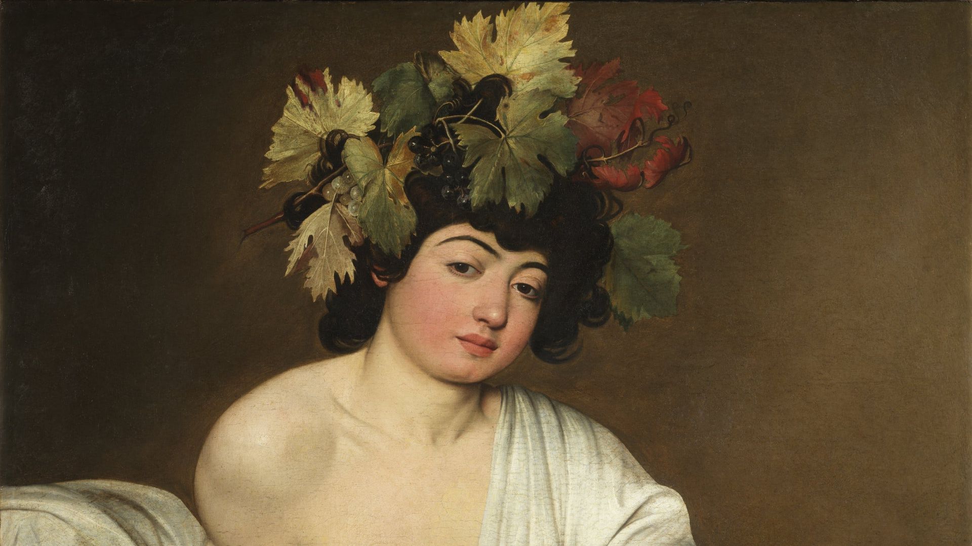 Giovane con corona di foglie e uva, drappeggiato in bianco.