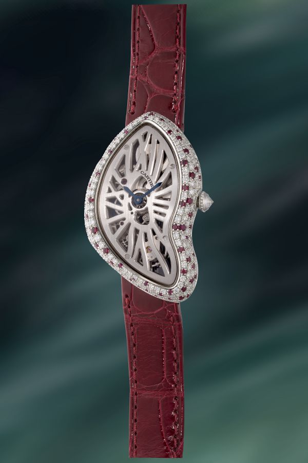 Orologio Cartier con cassa asimmetrica tempestata di diamanti e rubini, cinturino in pelle bordeaux.