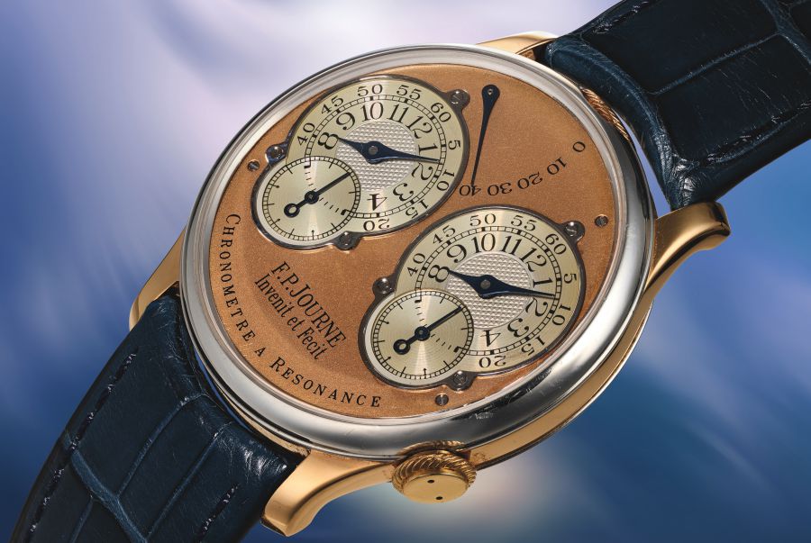 Orologio con quadrante color rame, tre sotto-quadranti e cinturino blu.
