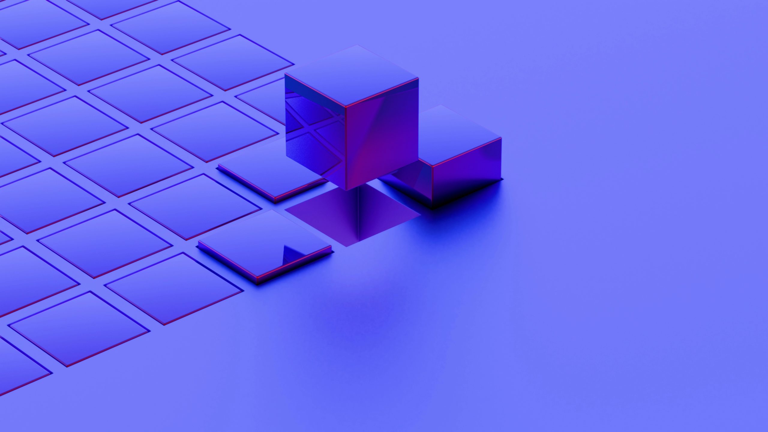 Cubi metallici lucidi su una griglia di quadrati blu.
