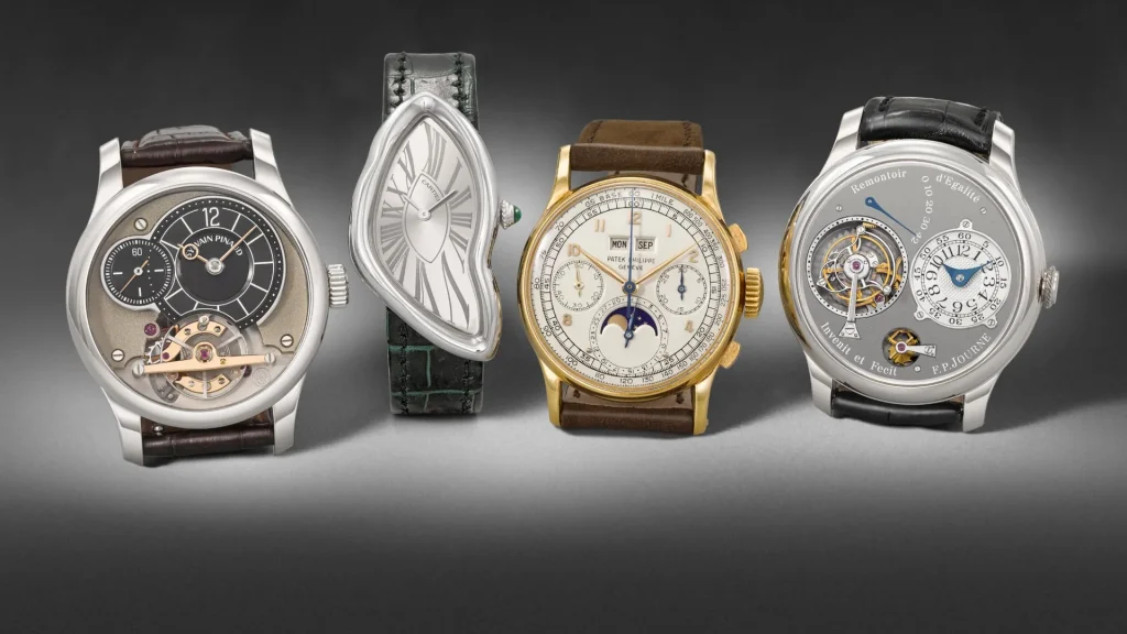 Quattro orologi di lusso, uno con quadrante a forma di goccia, uno in oro con fasi lunari, uno con tourbillon.