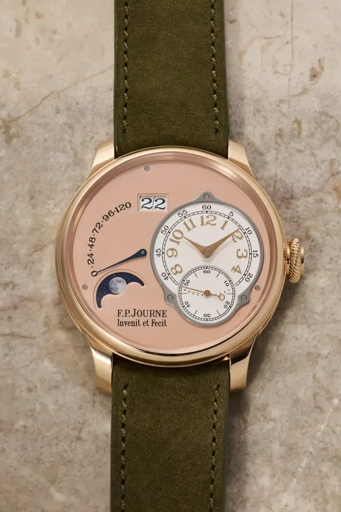 Orologio con quadrante rosa, fasi lunari, data e cinturino verde.